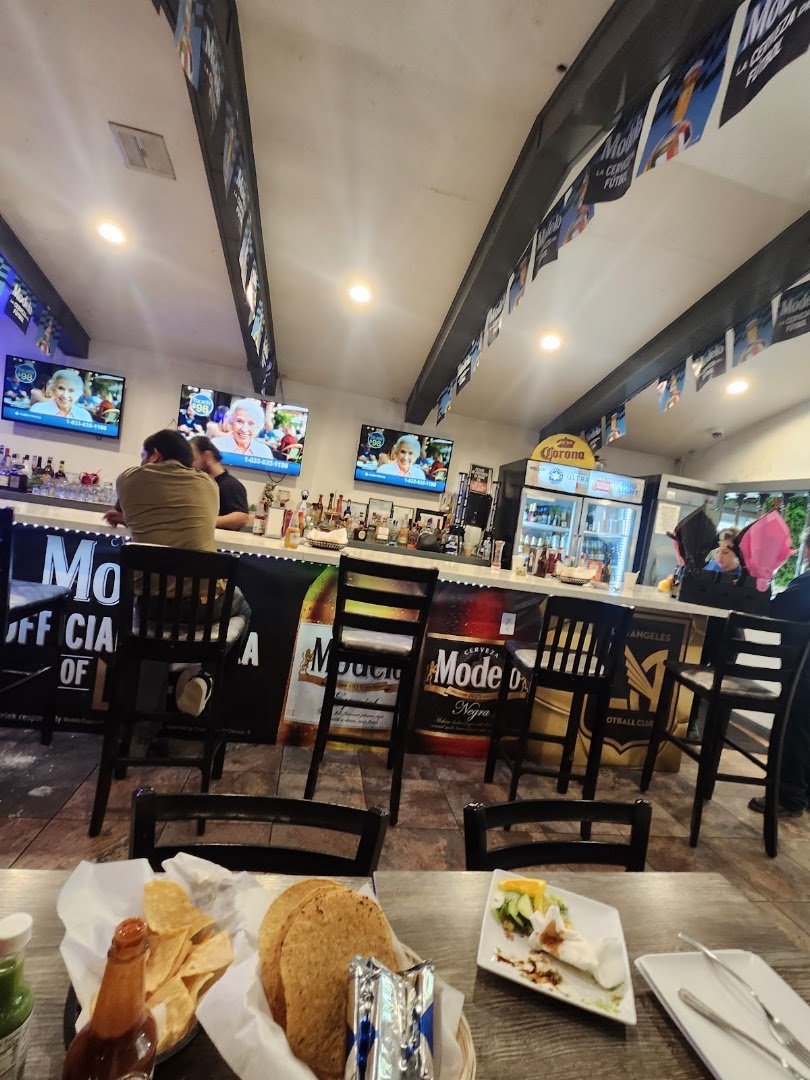 Drinks and small plates beside a bar.